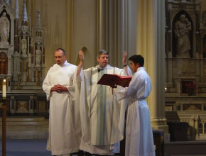 A priest reading from the Holy Bible during Mass.