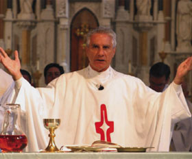 Priest praying over Sacrements.