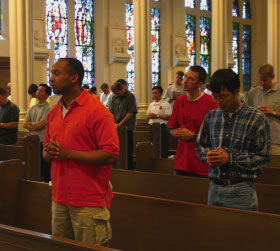 Students praying in St. John&rsquo;s Church.